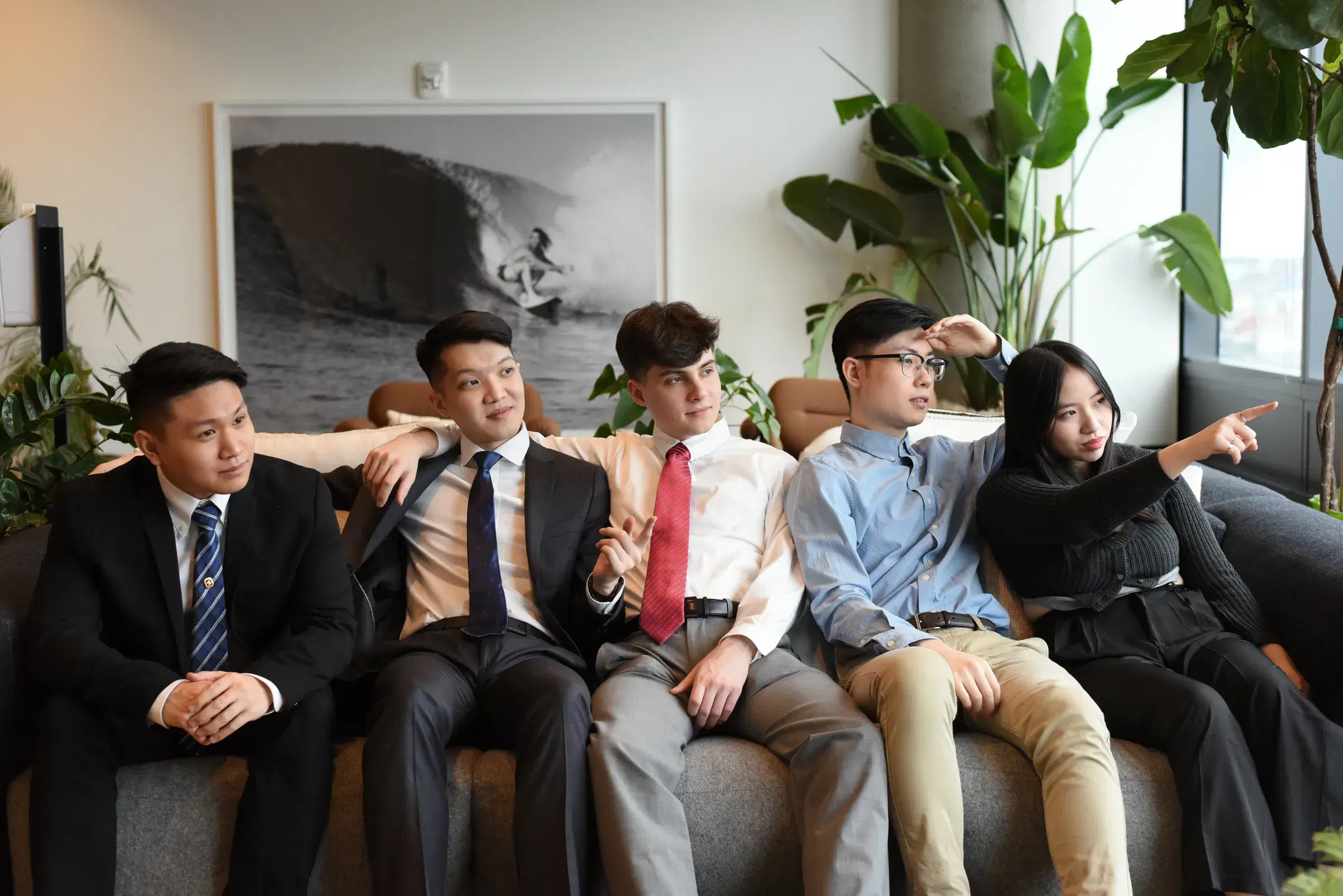 The Gambit Dev team on a couch, all looking toward the right